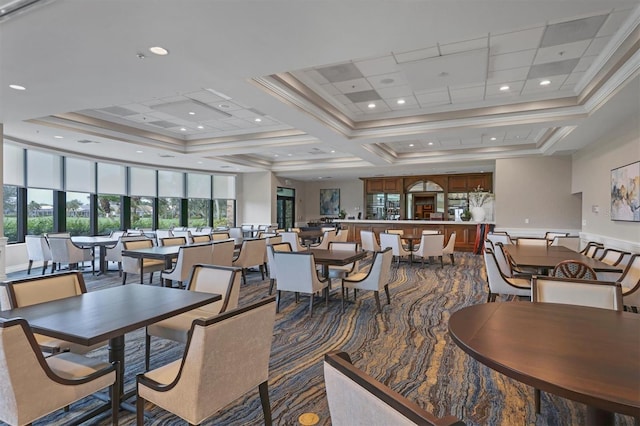 dining space with coffered ceiling, a towering ceiling, and ornamental molding