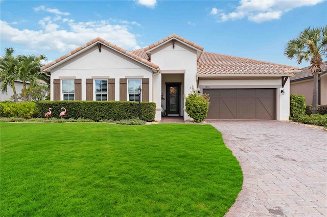 mediterranean / spanish home featuring a garage and a front lawn