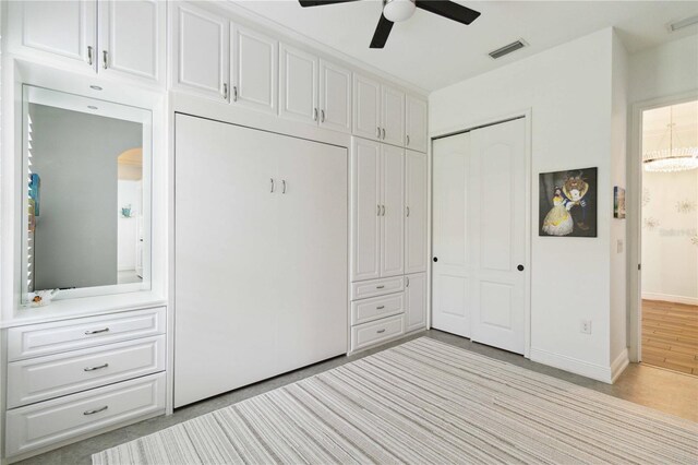 unfurnished bedroom featuring ceiling fan with notable chandelier