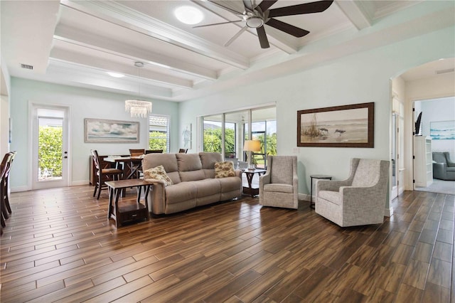 living room with ceiling fan with notable chandelier, a wealth of natural light, beamed ceiling, and dark hardwood / wood-style flooring