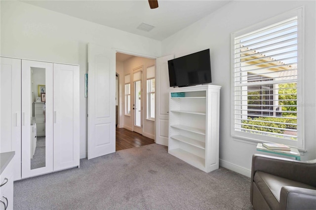 unfurnished bedroom with ceiling fan, a closet, and carpet