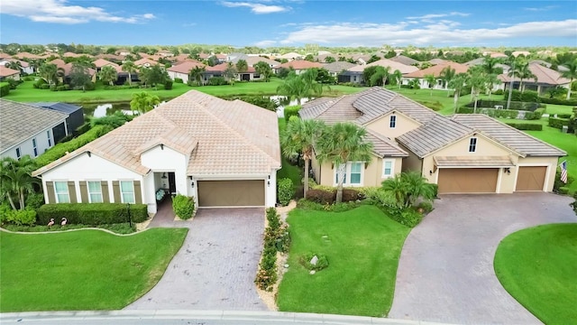 view of front of property with a garage and a front lawn