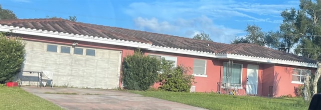 exterior space featuring a lawn and a garage