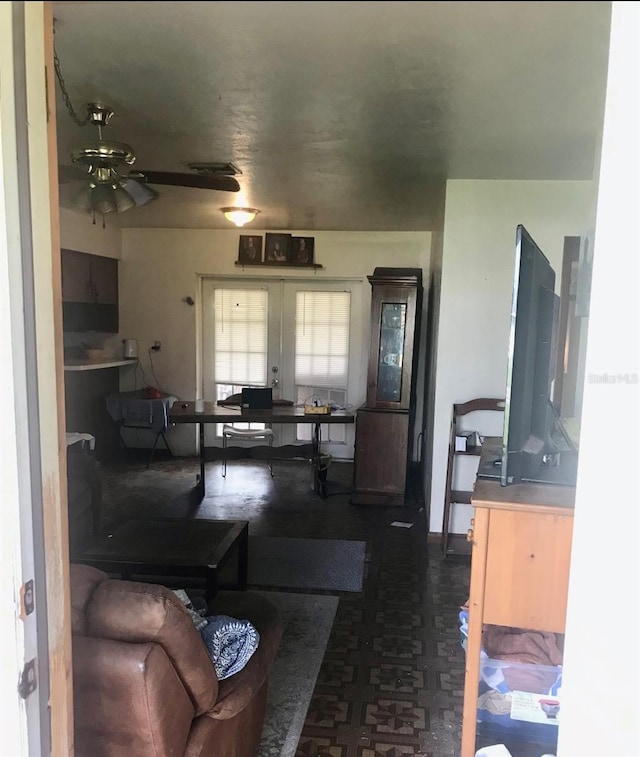 living room with ceiling fan and french doors