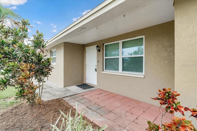 entrance to property featuring a patio