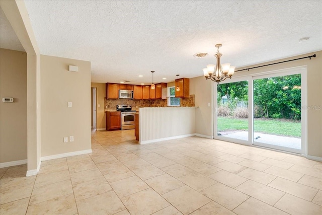 unfurnished living room with a textured ceiling, light tile patterned floors, and a notable chandelier