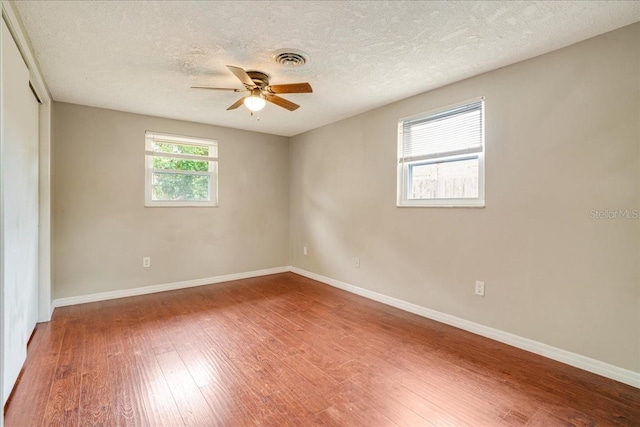 unfurnished room featuring ceiling fan, a textured ceiling, and wood-type flooring