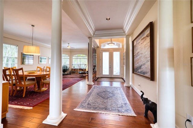 entryway with ornamental molding, wood-type flooring, ceiling fan, and french doors