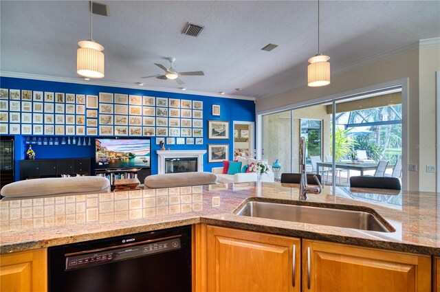 kitchen with black dishwasher, ornamental molding, sink, and decorative light fixtures