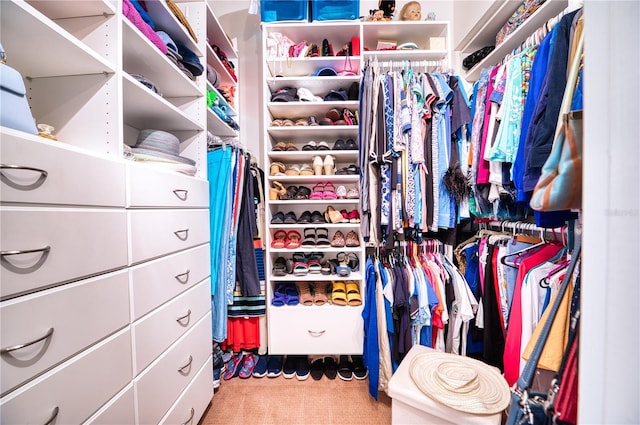 walk in closet featuring carpet floors