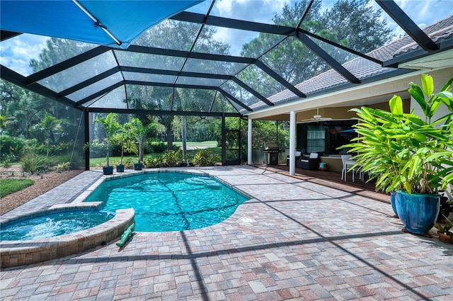 view of swimming pool featuring an in ground hot tub, glass enclosure, and a patio