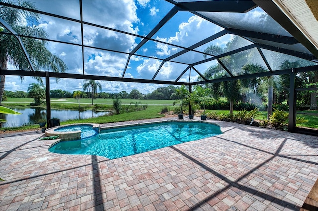 view of swimming pool featuring an in ground hot tub, glass enclosure, a water view, and a patio area