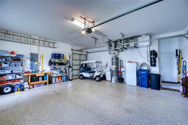 garage featuring a garage door opener, strapped water heater, and white refrigerator