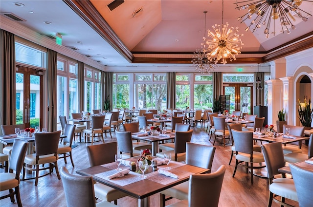 dining space featuring a notable chandelier, crown molding, and a wealth of natural light