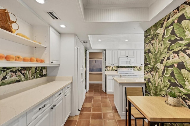 kitchen featuring white appliances, visible vents, light stone countertops, white cabinetry, and open shelves