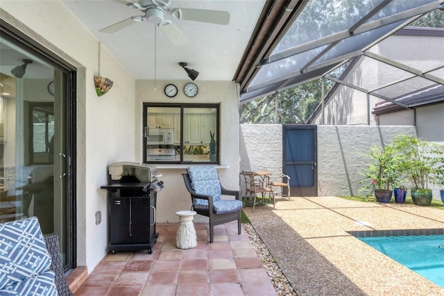 view of patio / terrace with glass enclosure, ceiling fan, and grilling area