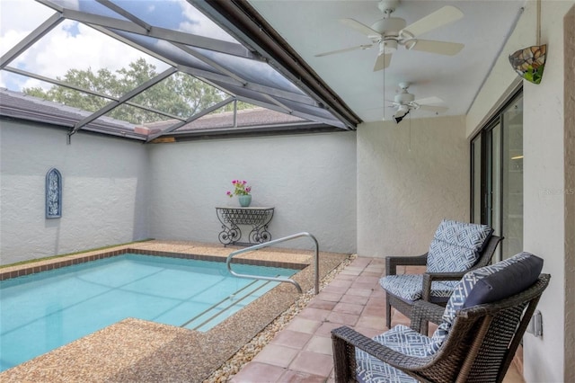 pool with ceiling fan, glass enclosure, and a patio area