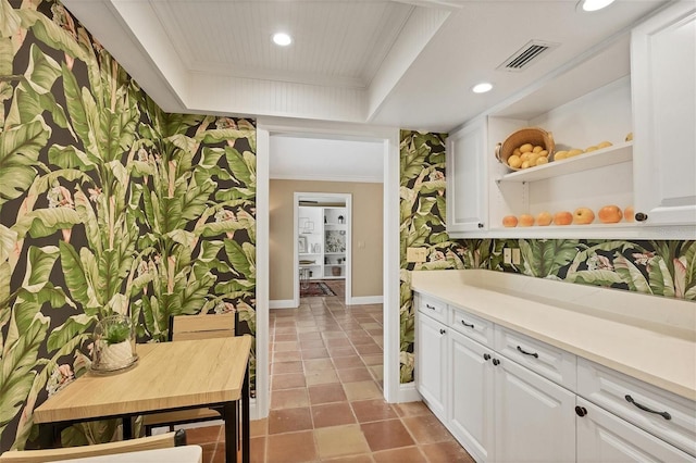 bar with recessed lighting, visible vents, a tray ceiling, and ornamental molding