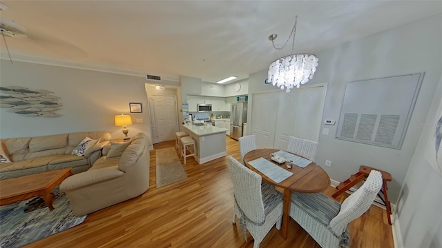 dining room featuring a notable chandelier and light hardwood / wood-style floors