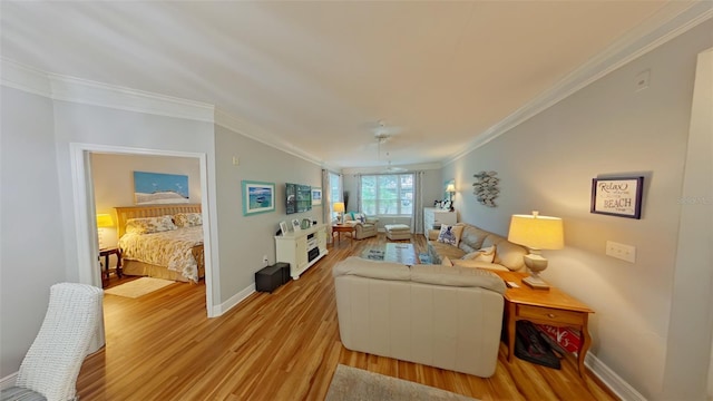 living room featuring ceiling fan, crown molding, and light hardwood / wood-style flooring