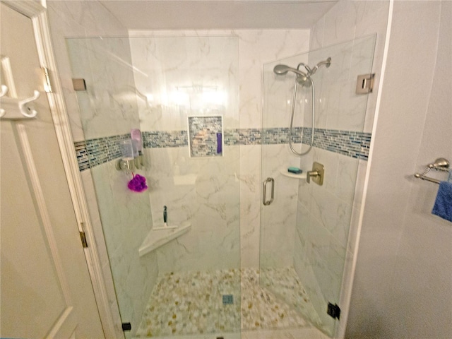 bathroom featuring a shower with shower door