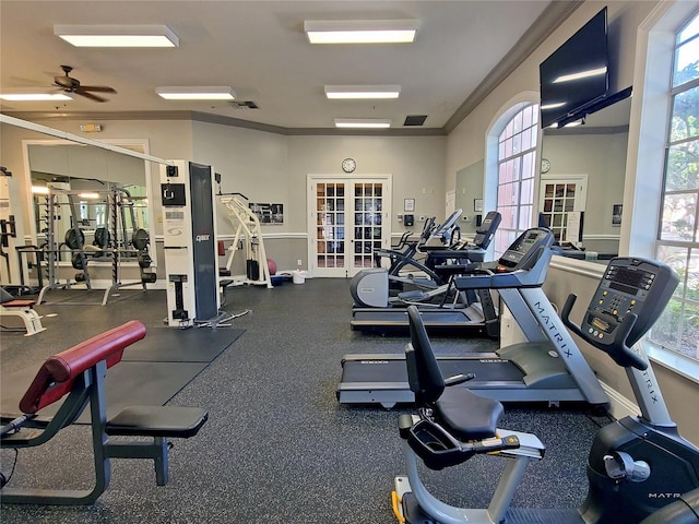 workout area with ornamental molding, french doors, ceiling fan, and a healthy amount of sunlight