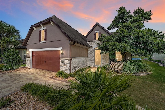 view of front of property featuring a yard and a garage