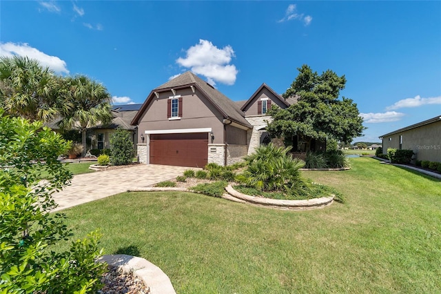 view of front of home with a front lawn and a garage