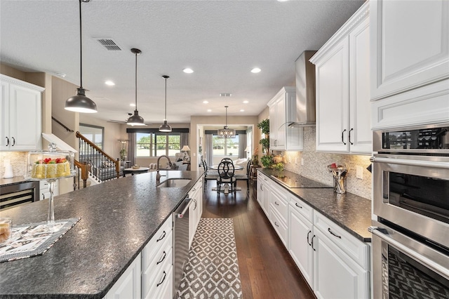 kitchen featuring white cabinets, hanging light fixtures, and sink