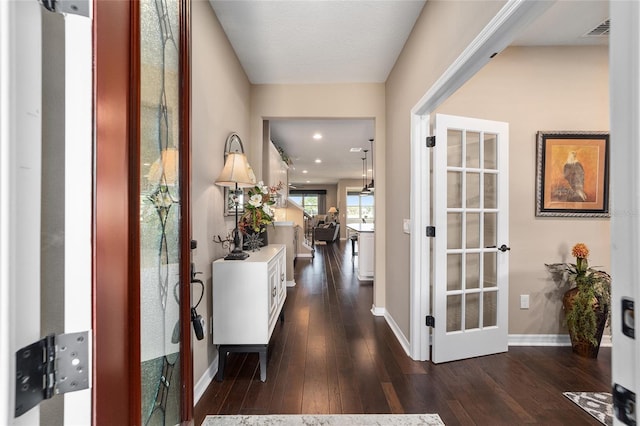 hallway with french doors and dark wood-type flooring