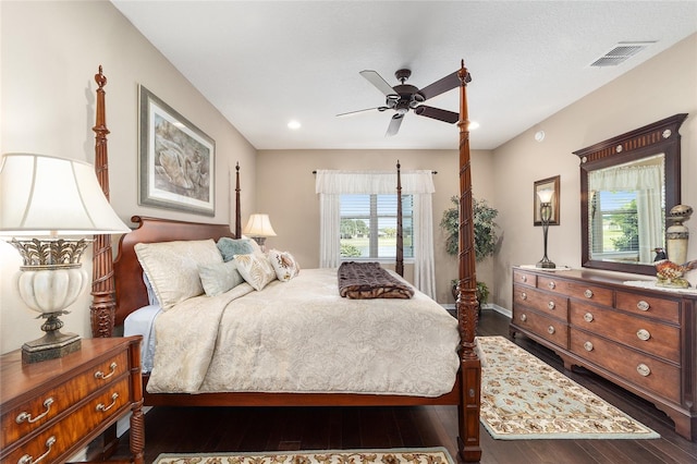 bedroom with dark hardwood / wood-style floors and ceiling fan