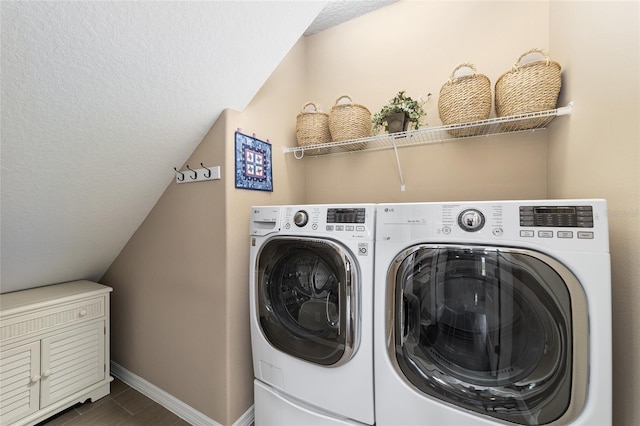 washroom with washing machine and clothes dryer