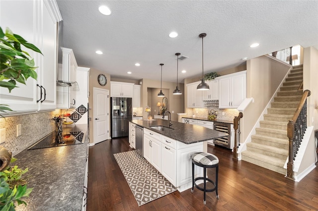 kitchen featuring white cabinetry, a kitchen island with sink, and appliances with stainless steel finishes