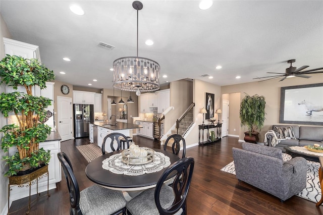 dining room featuring sink, ceiling fan with notable chandelier, and dark hardwood / wood-style floors