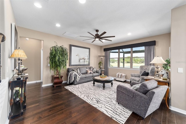 living room featuring a textured ceiling, dark hardwood / wood-style flooring, and ceiling fan