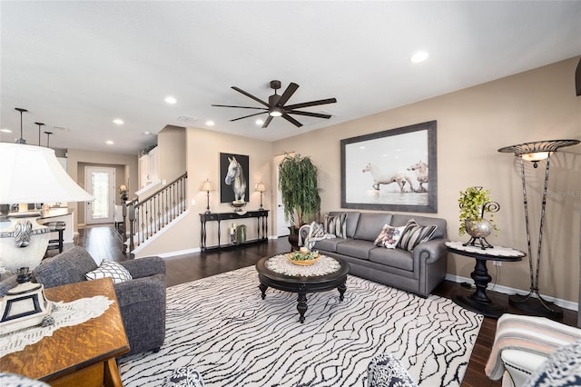 living room featuring dark hardwood / wood-style floors and ceiling fan