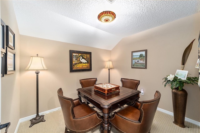 dining area with carpet flooring, a textured ceiling, and lofted ceiling