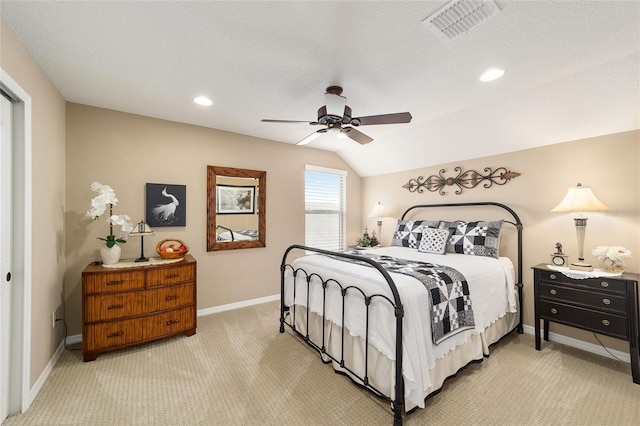 bedroom with a textured ceiling, light colored carpet, ceiling fan, and lofted ceiling