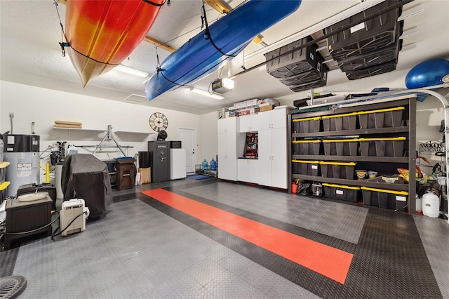 garage with hybrid water heater and a garage door opener