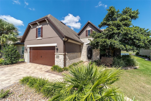 view of front of property featuring a garage and a front lawn