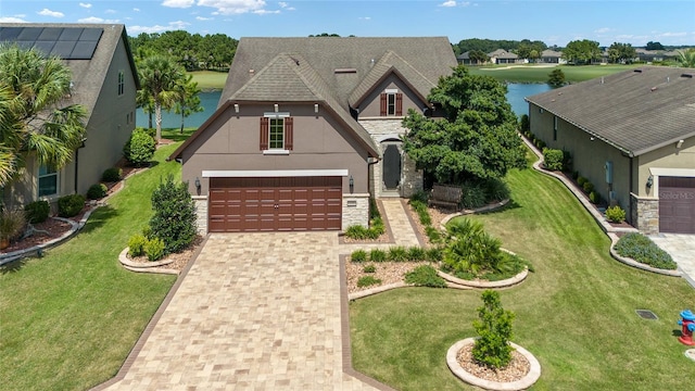 view of front facade with a water view and a garage