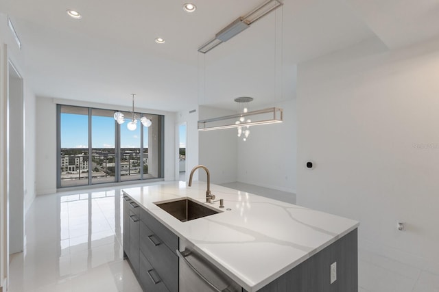 kitchen featuring light stone counters, sink, stainless steel dishwasher, a large island with sink, and an inviting chandelier