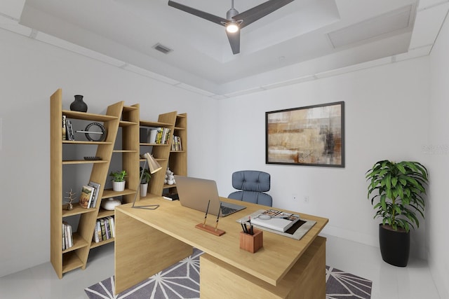 office area featuring a tray ceiling and ceiling fan