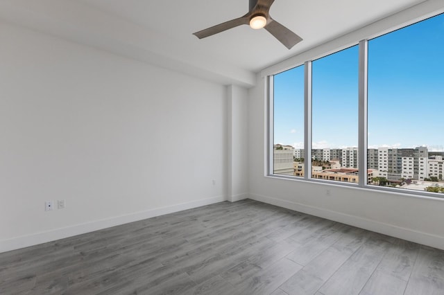 unfurnished room featuring ceiling fan and light hardwood / wood-style flooring