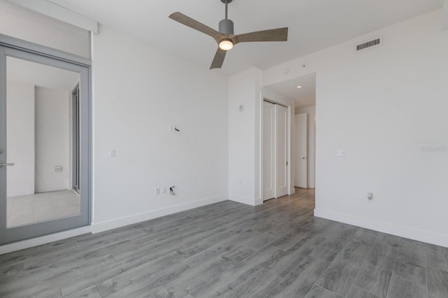 unfurnished room with ceiling fan and light wood-type flooring