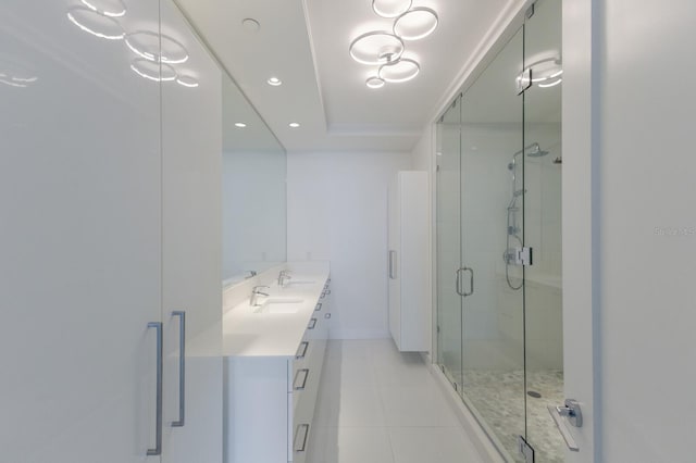 bathroom featuring vanity, a shower with door, and tile patterned floors