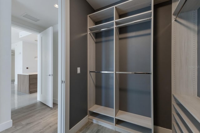 spacious closet with light hardwood / wood-style floors