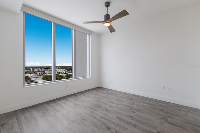 unfurnished room with light hardwood / wood-style floors and ceiling fan