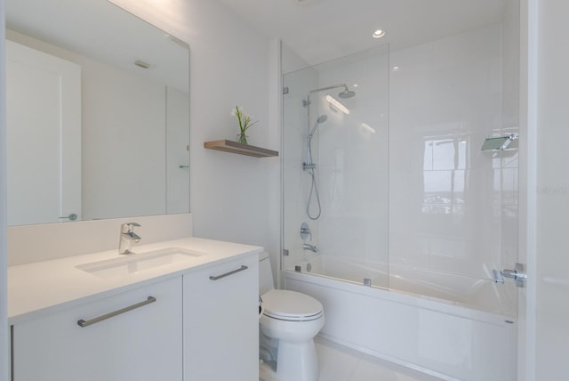 full bathroom with tiled shower / bath combo, vanity, toilet, and tile patterned floors