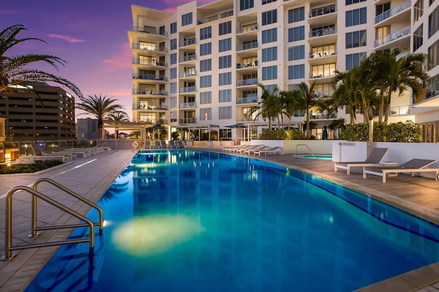 view of pool at dusk